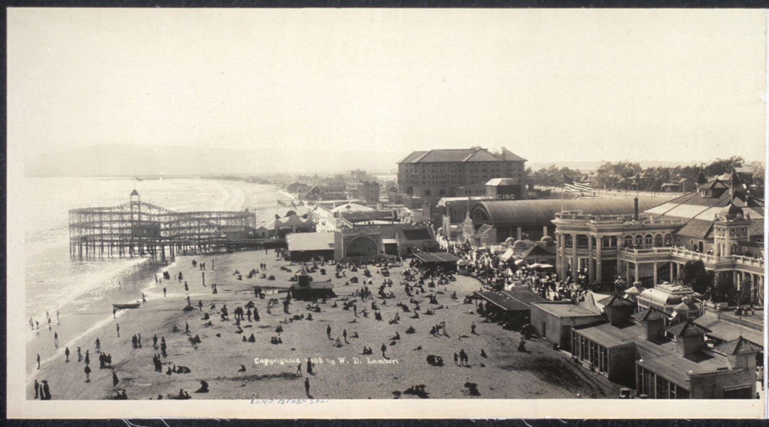 Panel 1 of 3 - A panoramic shot of Long Beach looking north up Pine Avenue and west along the shore, 1908. Before any Port development had begun, beach is all that could be seen. The First National Bank of Long Beach at First Street and Pine Avenue, built in 1906 (seen in Panel 3), is still a familiar landmark today and houses Italian restaurant L'Opera.