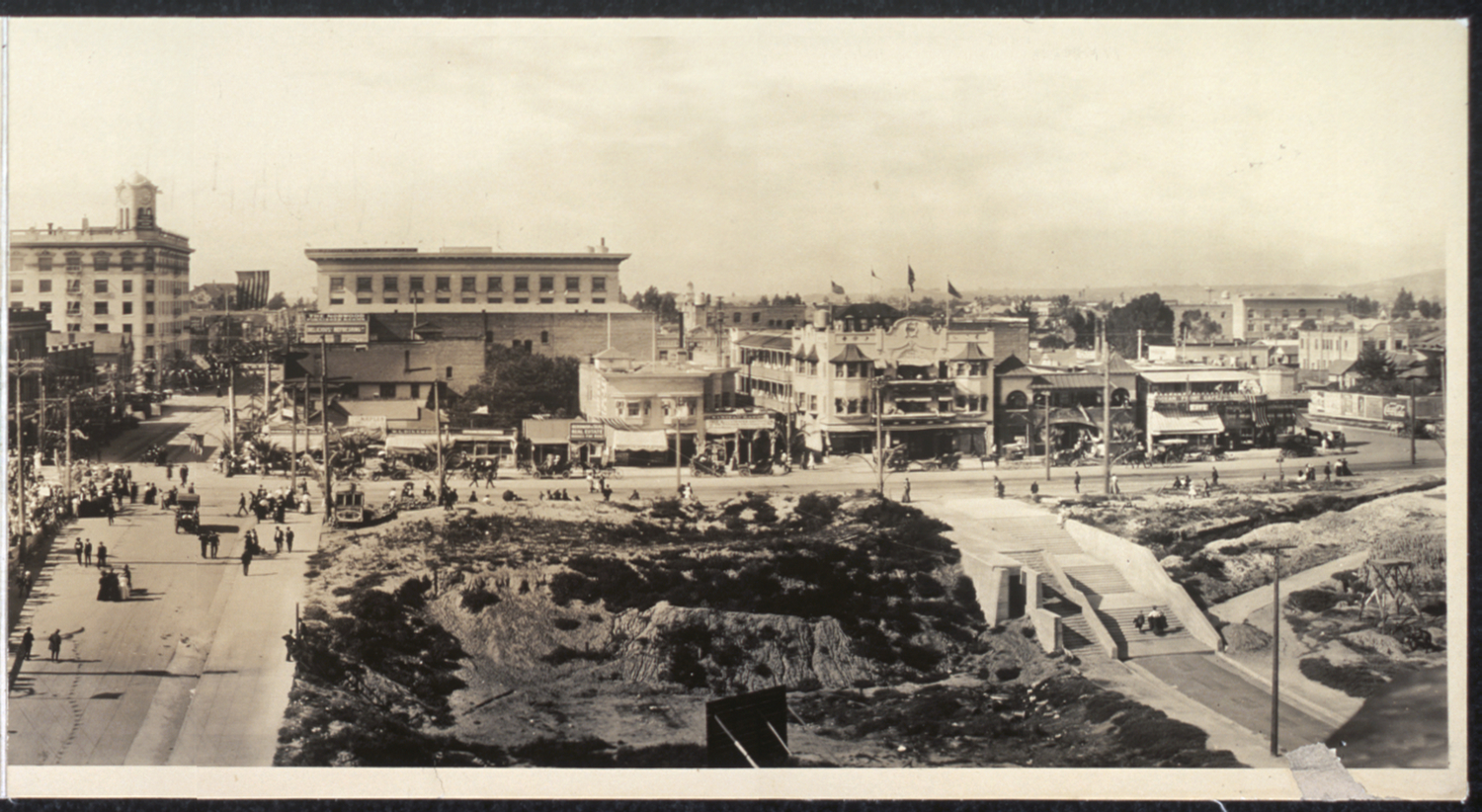 Panel 3 of 3 - A panoramic shot of Long Beach looking north up Pine Avenue and west along the shore, 1908. Before any Port development had begun, beach is all that could be seen. The First National Bank of Long Beach at First Street and Pine Avenue, built in 1906 (at left with clock tower), is still a familiar landmark today and houses Italian restaurant L'Opera.