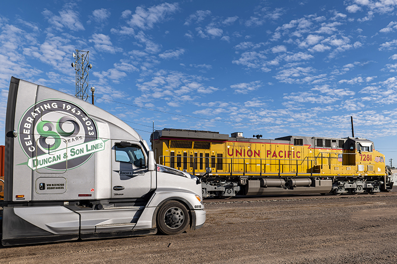 Union Pacific locomotive with Duncan and Son Lines truck in foreground